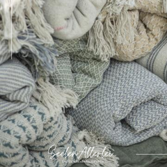 Picknickdecken in verschiedenen Farben liegen aufgerollt übereinander