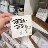 Serviette von Edition Gute Geister mit der Aufschrift Tortentag und dem berühmten Fuchs in Strichzeichnung von Harriet Grundmann, der Designerin der Servietten.