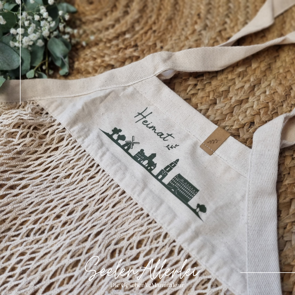 Netzbeutel in Naturoptik mit der Heimatsilhouette von Coesfeld und der Aufschrift Heinmt