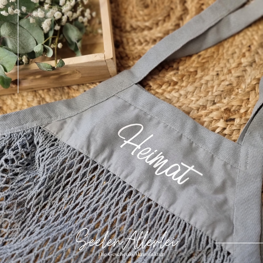 grauer Netzbeutel mit der Aufschrift Heimat
