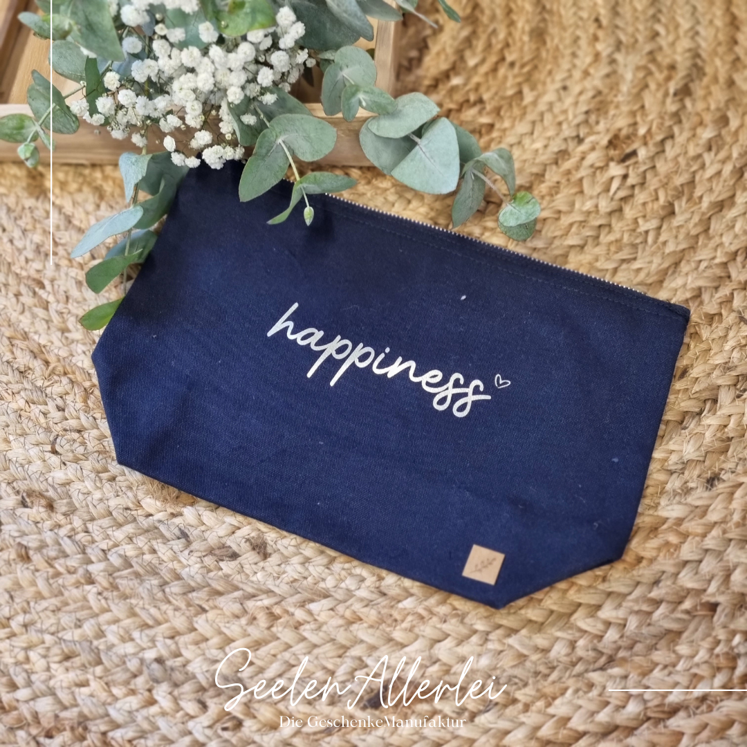 blaue kleine Kulturtasche mit der Aufschrift happiness