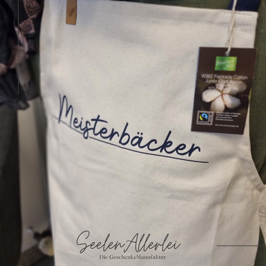 Kinderschürze mit dem Aufrduck Meisterbäcker als Fairtrade Produkt in naturfarben